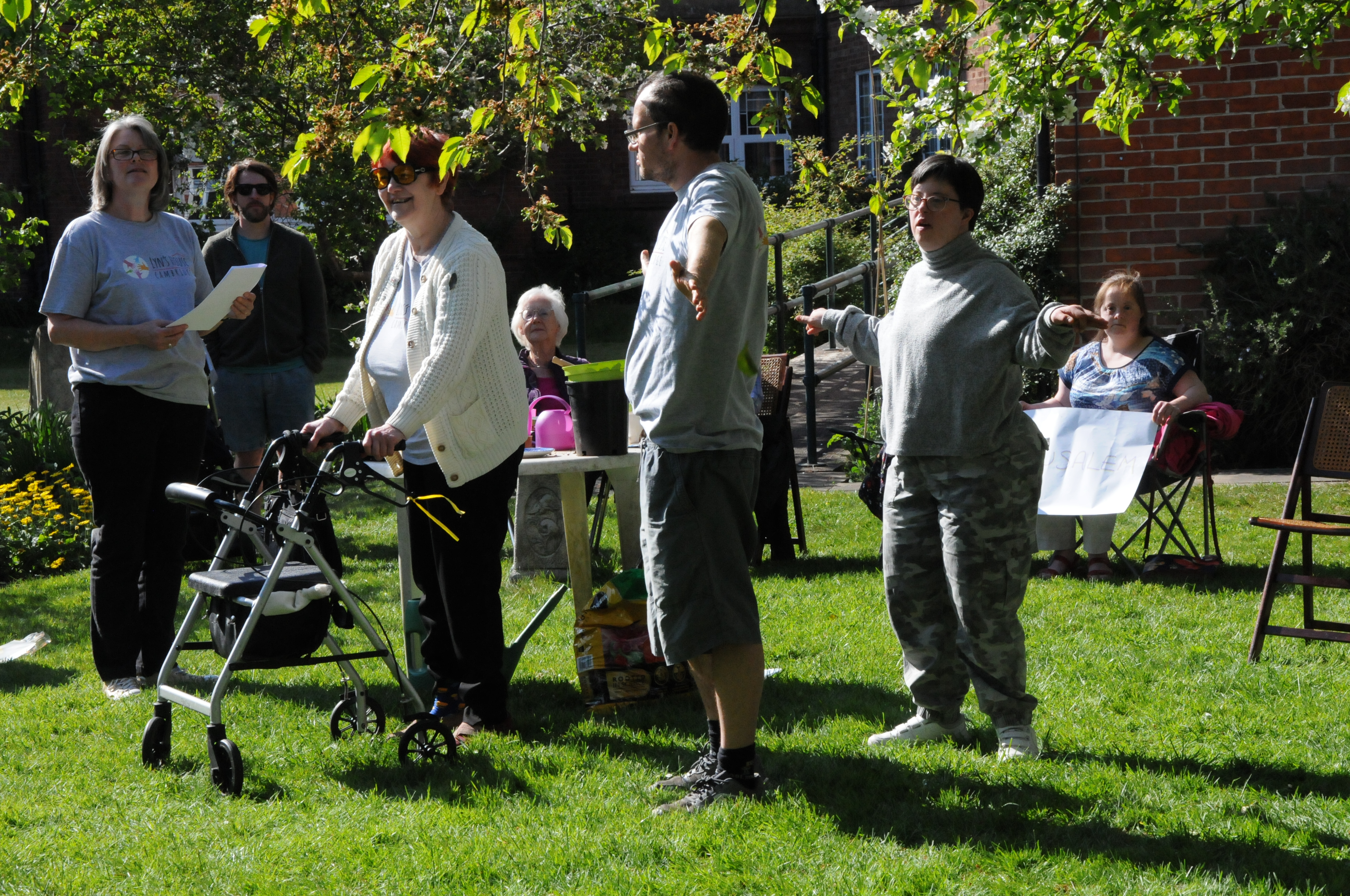 A mixed-ability group performing drama in an outdoor setting
