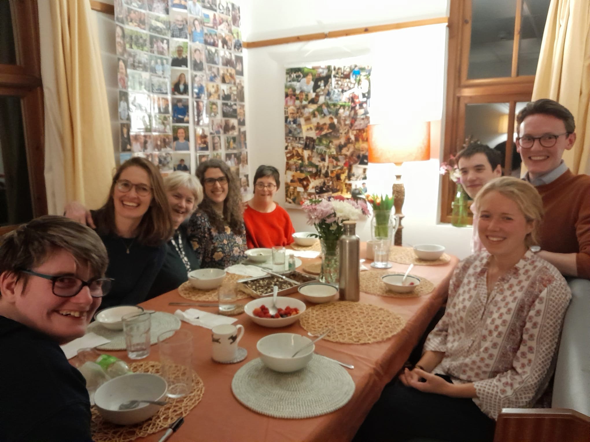 Small group round a dinner table smiling